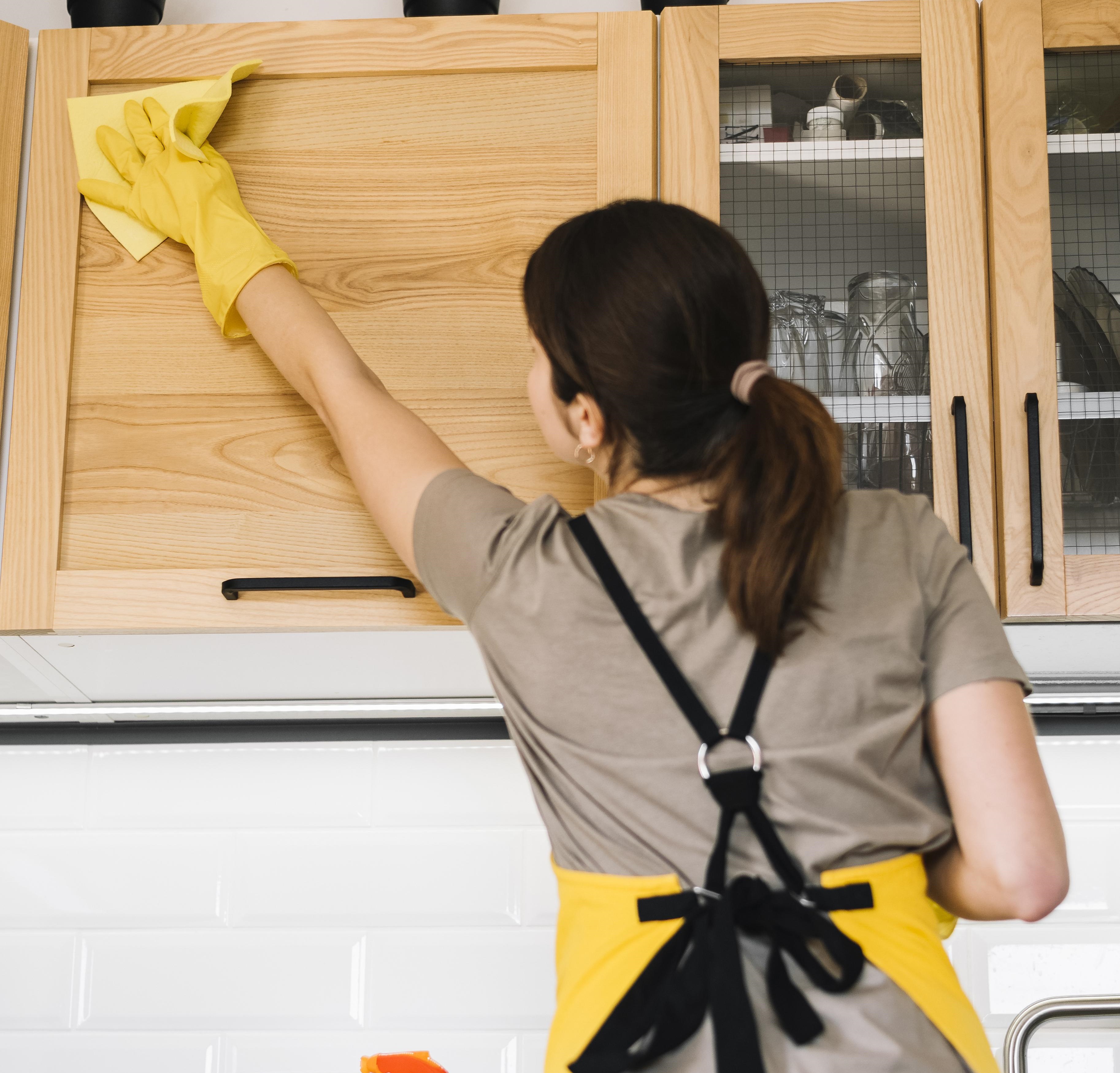 Medium Shot Woman Cleaning Cabinet