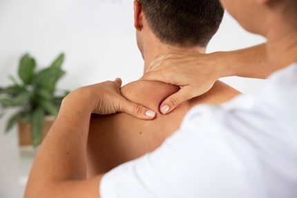 Physiotherapist Performing Therapeutic Massage Male Client