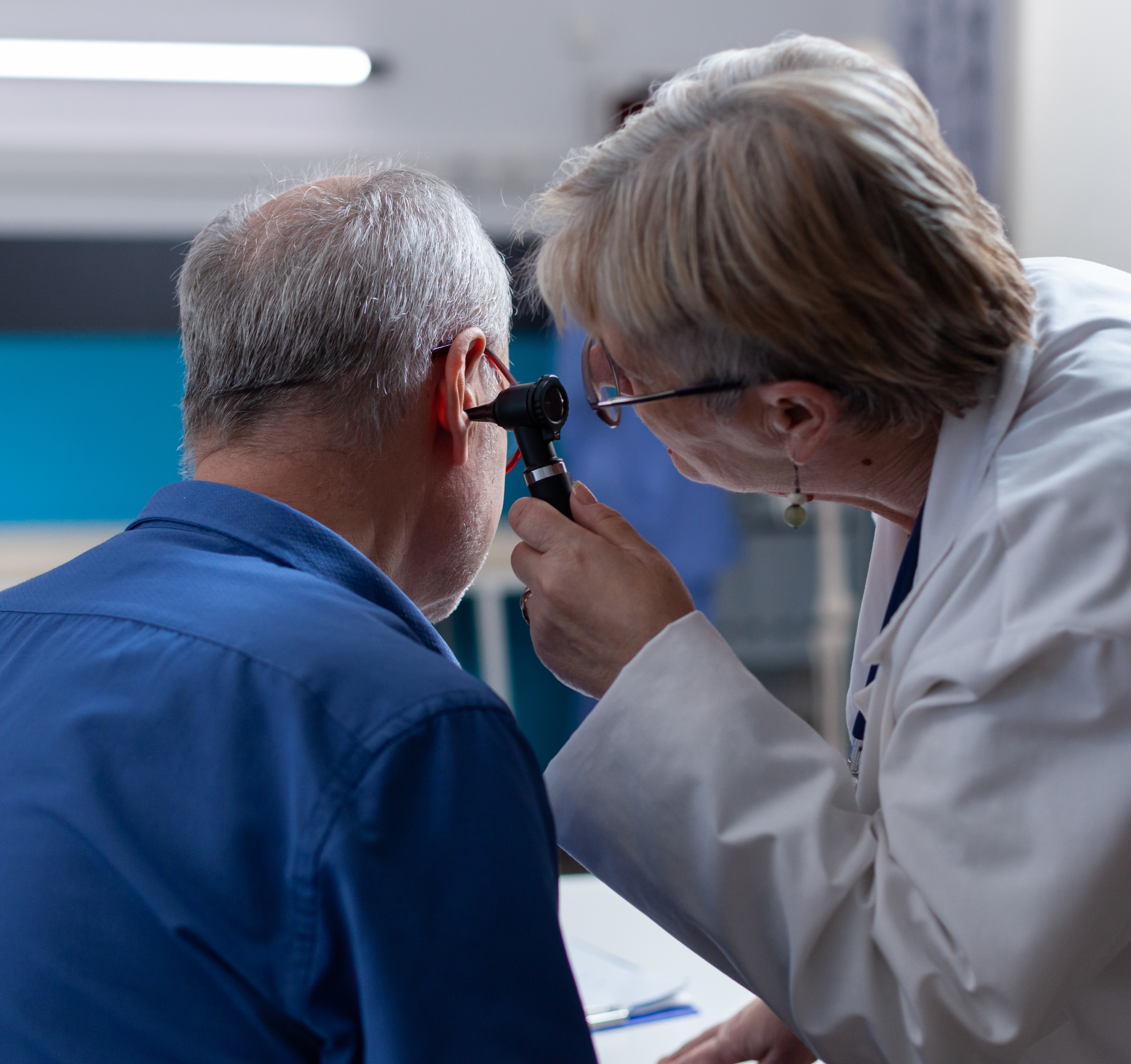 Physician Holding Otoscope Ear Consultation Patient Checkup Visit Woman Doctor Using Otology Instrument Examine Infection Give Medical Advice Senior Man